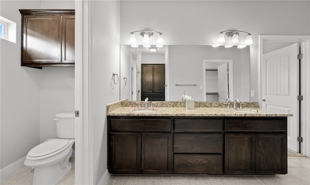 bathroom featuring tile patterned floors, vanity, and toilet