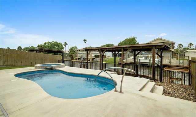 view of pool featuring an in ground hot tub, a patio, and a water view