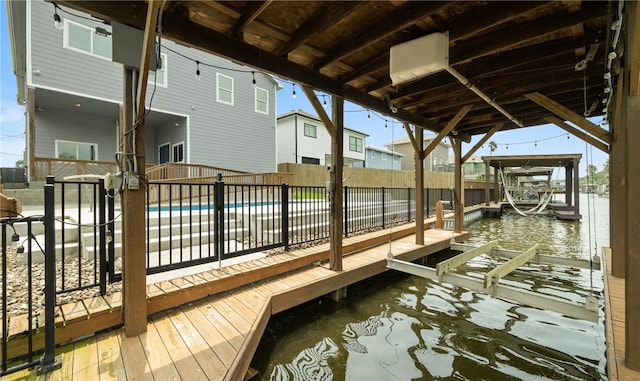 view of dock featuring a water view and a fenced in pool