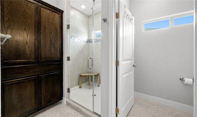 bathroom with tile patterned floors and a shower with shower door