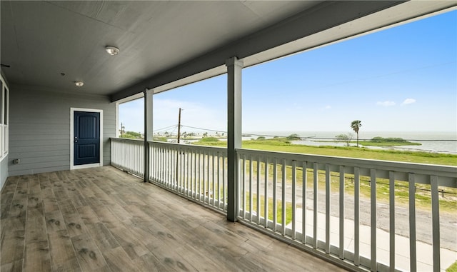 wooden terrace featuring a water view