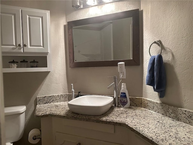4117 Cork Dr, Corpus Christi, TX 78413 - half bathroom featuring a textured wall and vanity