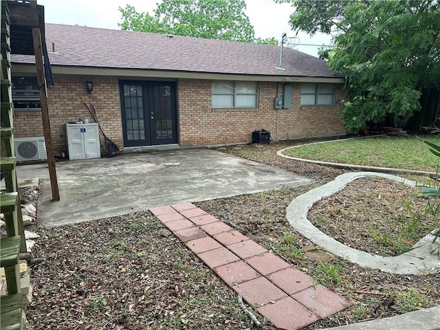 4117 Cork Dr, Corpus Christi, TX 78413 - back of house with french doors, brick siding, a patio area, and a shingled roof