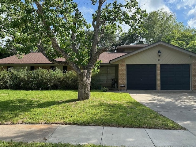 4117 Cork Dr, Corpus Christi, TX 78413 - view of front of property featuring a garage, concrete driveway, a front lawn, and brick siding