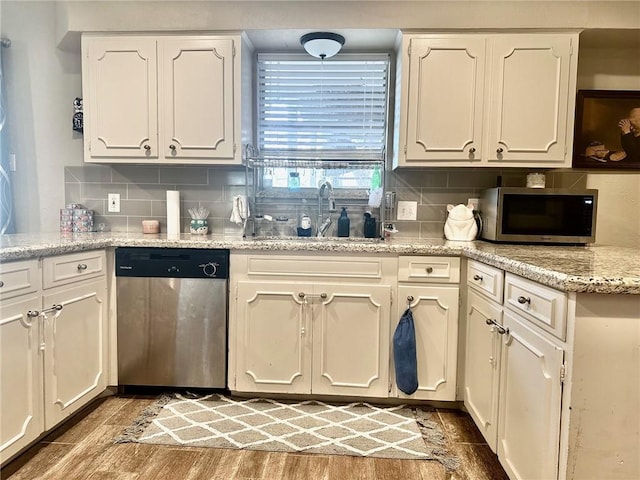 4117 Cork Dr, Corpus Christi, TX 78413 - kitchen featuring appliances with stainless steel finishes, white cabinets, and wood finished floors