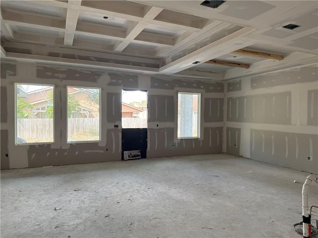 unfurnished room featuring a wealth of natural light and coffered ceiling