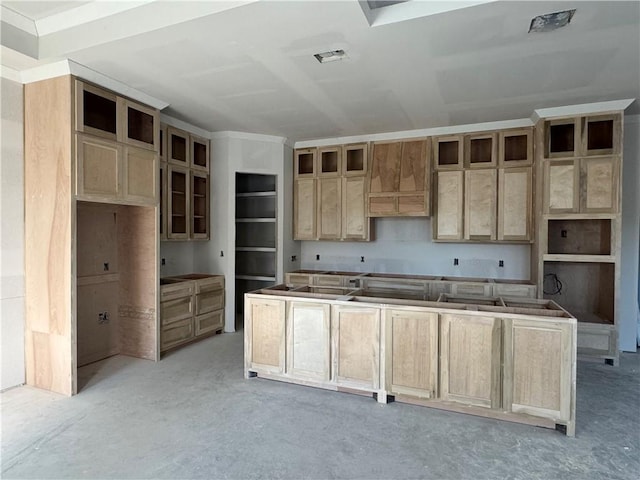 kitchen with glass insert cabinets, a kitchen island, and concrete floors