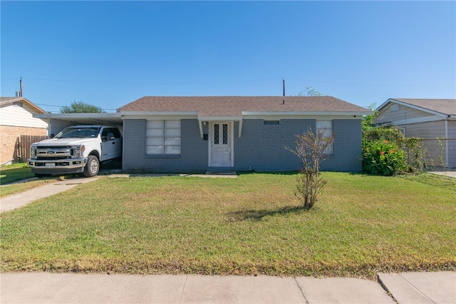 single story home with a front yard and a carport