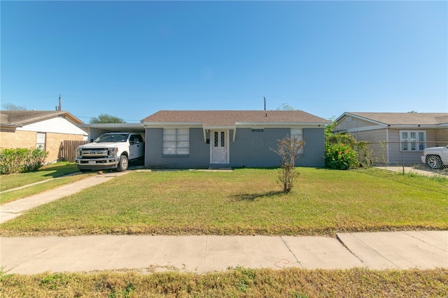 ranch-style house featuring a front lawn and a carport