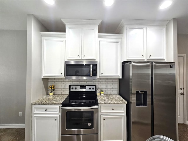 2021 Orange St, Corpus Christi, TX 78418 - kitchen featuring stainless steel appliances, tasteful backsplash, white cabinetry, light stone counters, and recessed lighting