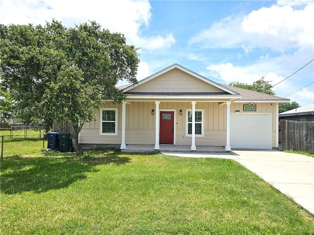 2021 Orange St, Corpus Christi, TX 78418 - view of front of house with a garage, a porch, driveway, and board and batten siding