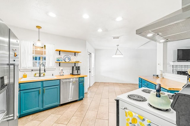 3105 Quebec Dr, Corpus Christi, TX 78414 - kitchen featuring appliances with stainless steel finishes, blue cabinets, wall chimney range hood, wood counters, and a sink