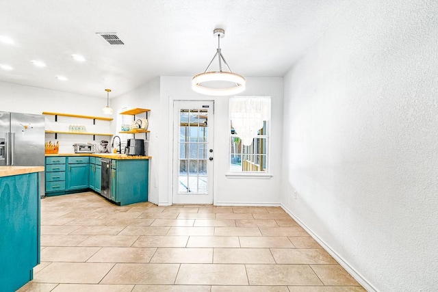3105 Quebec Dr, Corpus Christi, TX 78414 - kitchen with wood counters, open shelves, blue cabinetry, stainless steel appliances, and pendant lighting