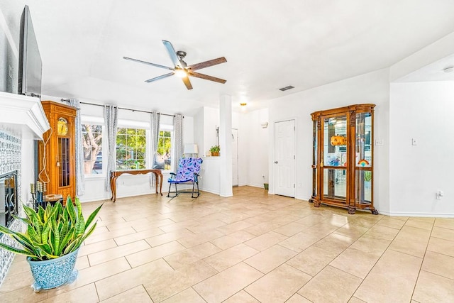 3105 Quebec Dr, Corpus Christi, TX 78414 - sitting room with ceiling fan, a glass covered fireplace, light tile patterned flooring, and baseboards