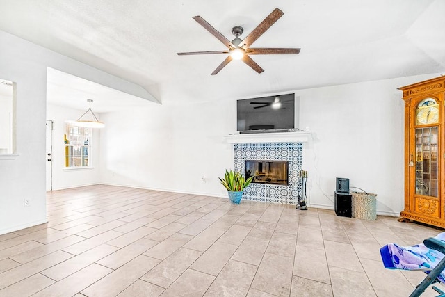 3105 Quebec Dr, Corpus Christi, TX 78414 - unfurnished living room featuring ceiling fan, a tiled fireplace, and baseboards