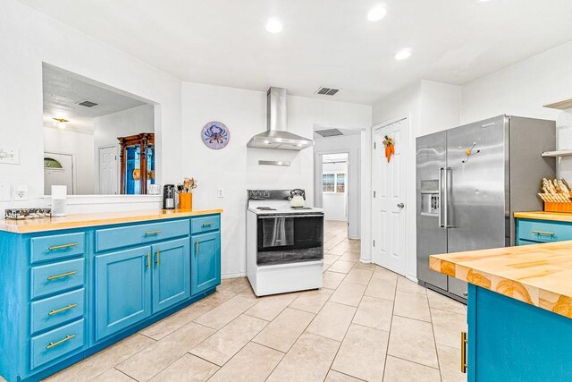 3105 Quebec Dr, Corpus Christi, TX 78414 - kitchen with white range with electric stovetop, wall chimney exhaust hood, high end fridge, blue cabinetry, and wood counters