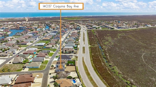 drone / aerial view featuring a water view and a residential view