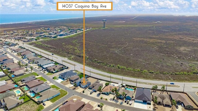 birds eye view of property with a water view and a residential view