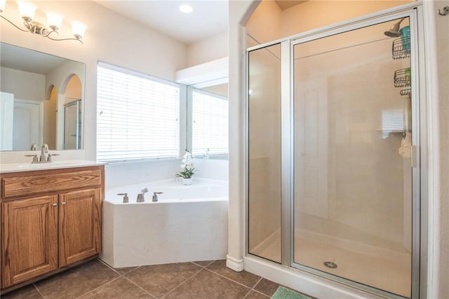 bathroom with a shower stall, tile patterned floors, vanity, and a garden tub