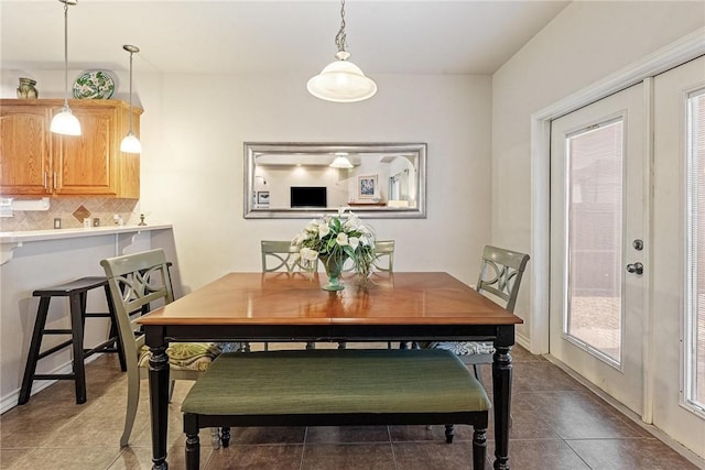 tiled dining space featuring plenty of natural light