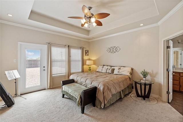 bedroom featuring a tray ceiling, access to exterior, and carpet floors