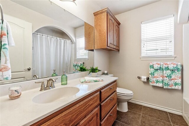 full bathroom with vanity, tile patterned flooring, toilet, a shower with shower curtain, and baseboards
