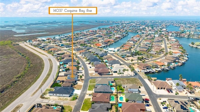 drone / aerial view with a water view and a residential view