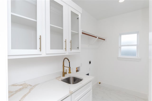 laundry area with cabinets, hookup for a washing machine, hookup for an electric dryer, and sink