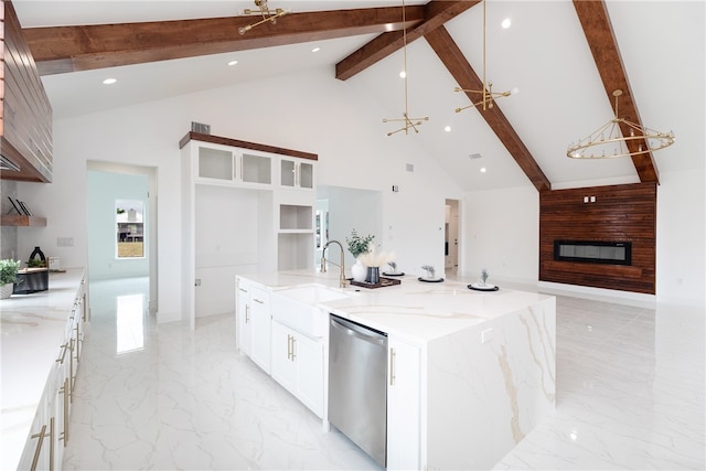 kitchen featuring dishwasher, a large island, light stone counters, and beam ceiling