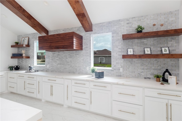 kitchen featuring light stone countertops, plenty of natural light, and decorative backsplash