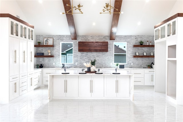 kitchen with white cabinets, lofted ceiling with beams, a center island, and backsplash