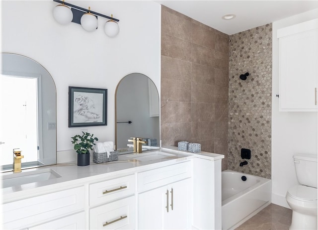 full bathroom with vanity, tile patterned floors, toilet, and tiled shower / bath combo