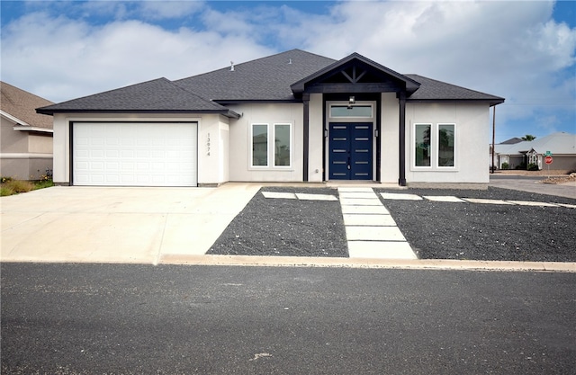 13974 Blackbeard Dr, Corpus Christi, TX 78418 - view of front of property with a garage, concrete driveway, stucco siding, and roof with shingles
