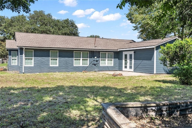 rear view of property with a lawn and a patio area