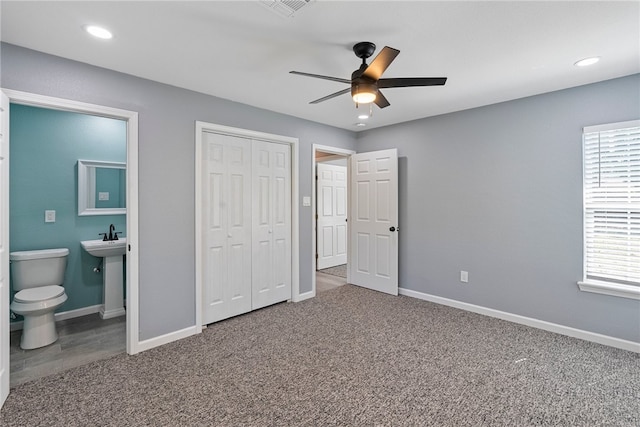 unfurnished bedroom featuring carpet, ceiling fan, and ensuite bath