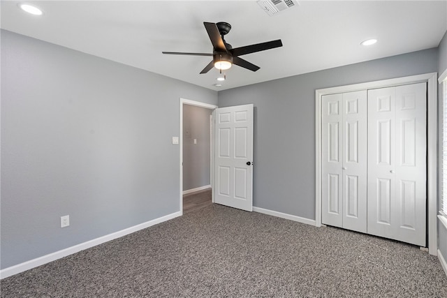 unfurnished bedroom with carpet, ceiling fan, and a closet