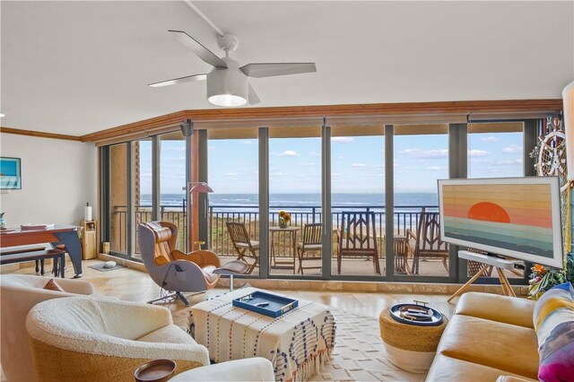 tiled living room with ceiling fan, crown molding, and track lighting