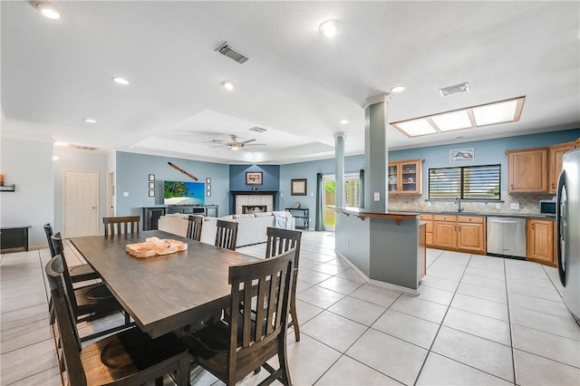 6041 King Trl, Corpus Christi, TX 78414 - dining room with plenty of natural light, light tile patterned floors, ceiling fan, recessed lighting, and a fireplace