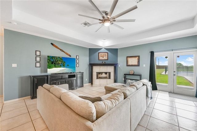 6041 King Trl, Corpus Christi, TX 78414 - living room with a raised ceiling, light tile patterned floors, ceiling fan, crown molding, and baseboards