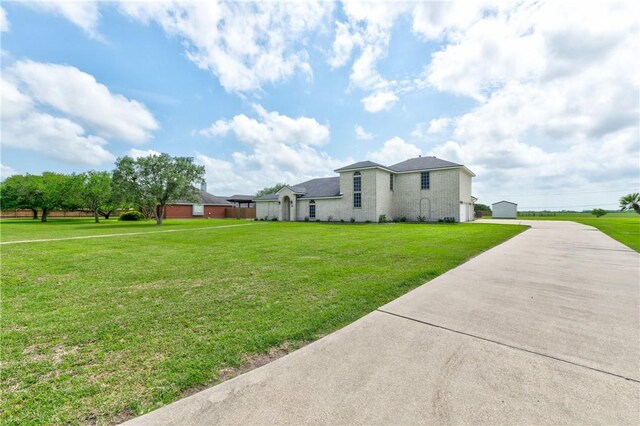 6041 King Trl, Corpus Christi, TX 78414 - view of property exterior with driveway and a lawn
