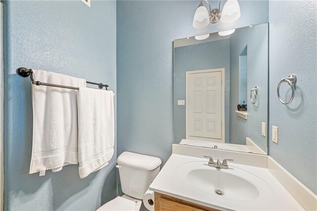 6041 King Trl, Corpus Christi, TX 78414 - bathroom with toilet, vanity, and a textured wall