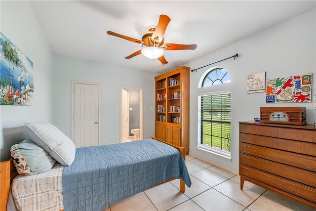 6041 King Trl, Corpus Christi, TX 78414 - bedroom with multiple windows, light tile patterned flooring, connected bathroom, and ceiling fan