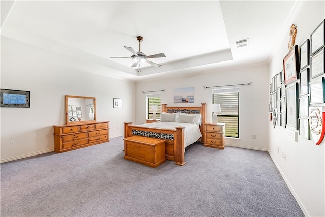 6041 King Trl, Corpus Christi, TX 78414 - carpeted bedroom with multiple windows, a raised ceiling, baseboards, and ceiling fan