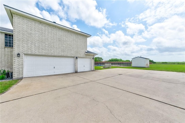 6041 King Trl, Corpus Christi, TX 78414 - garage featuring concrete driveway and a storage shed