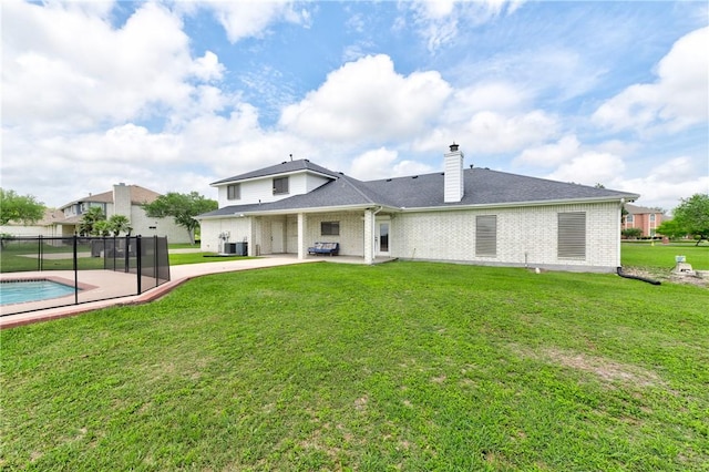 6041 King Trl, Corpus Christi, TX 78414 - back of property with a patio, a chimney, brick siding, and a lawn