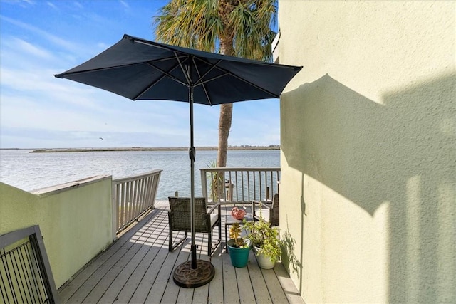 wooden deck featuring a water view