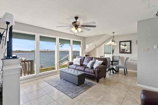 living room with a water view, light tile patterned floors, and ceiling fan