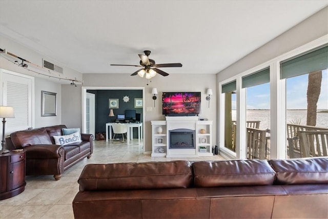 tiled living room featuring ceiling fan