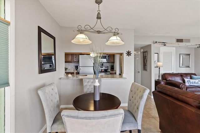 dining room with sink and light tile patterned floors