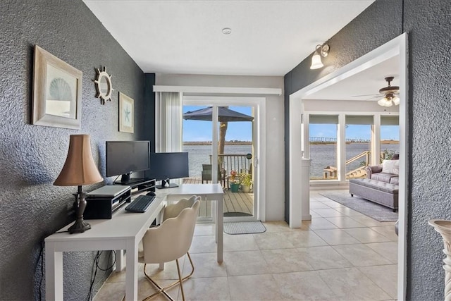 office area featuring ceiling fan, plenty of natural light, and light tile patterned floors